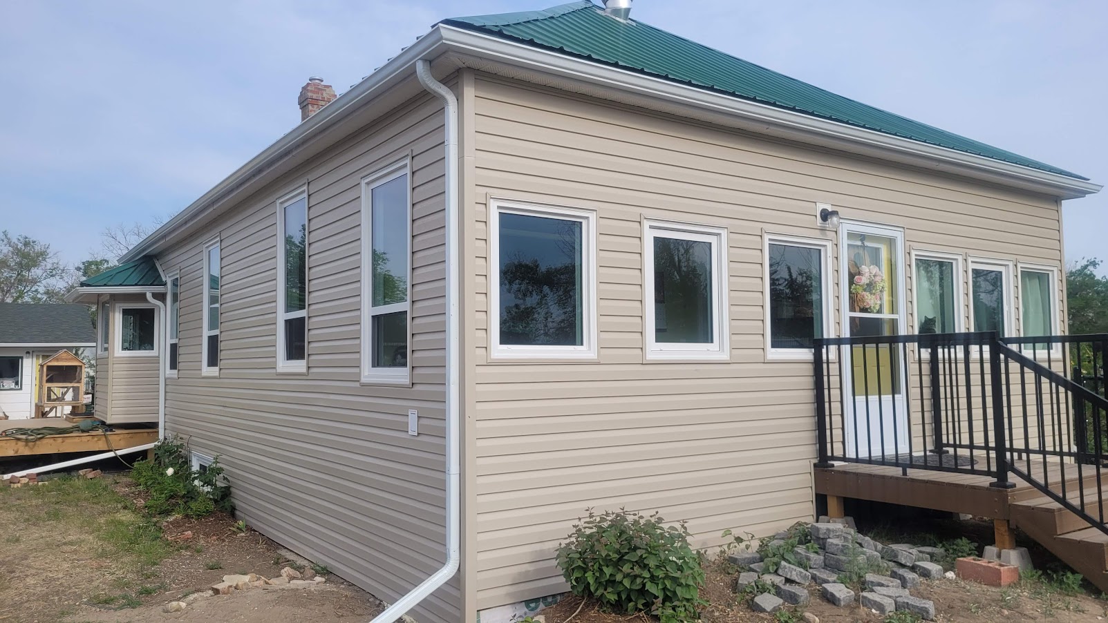 Completed tan vinyl siding renovation on a Suffield home